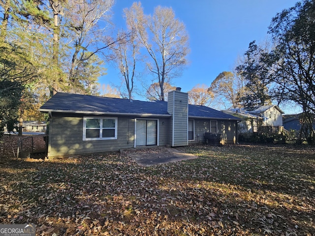 rear view of property with a yard