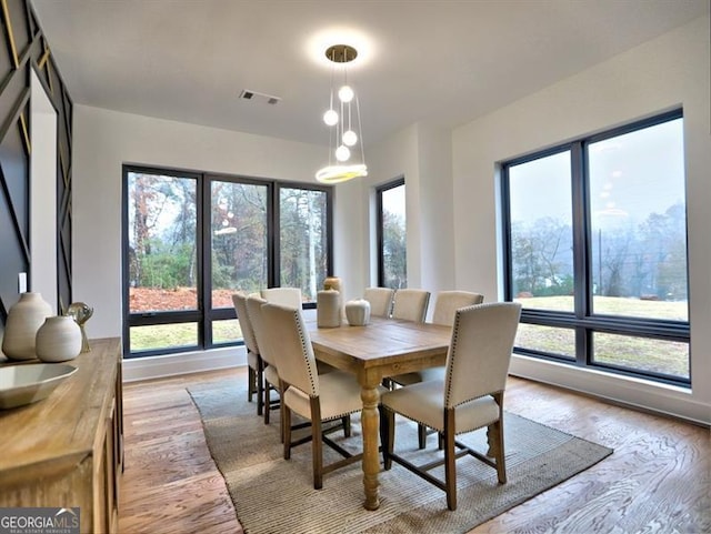 dining area with light wood-type flooring and a wealth of natural light