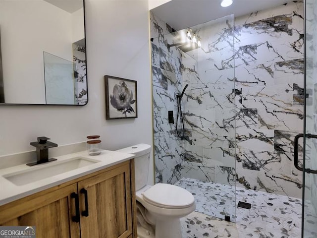 bathroom with vanity, an enclosed shower, and toilet