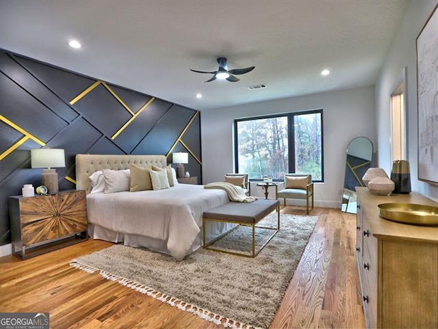 bedroom with ceiling fan and hardwood / wood-style flooring