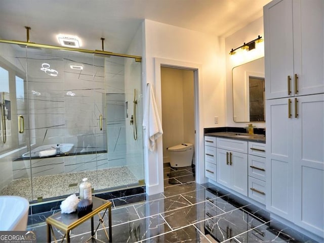 bathroom with vanity, toilet, and a shower with door