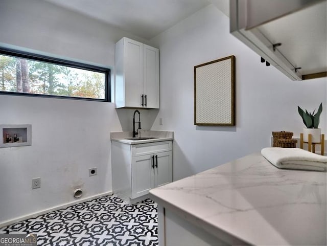 laundry area featuring sink, washer hookup, cabinets, hookup for an electric dryer, and track lighting