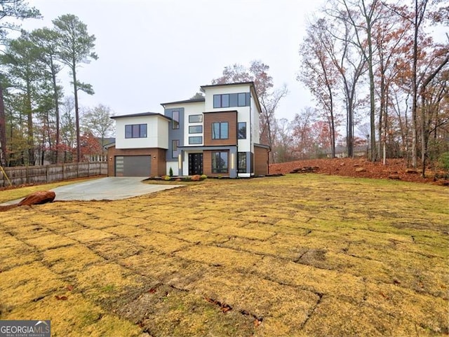 contemporary house with a garage and a front lawn