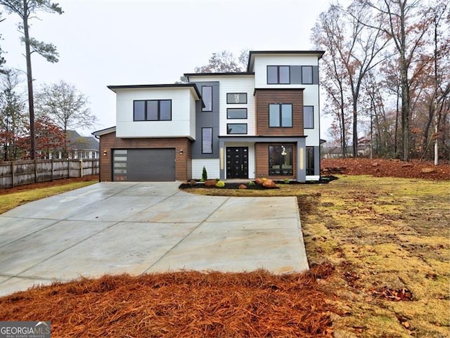 contemporary house with a garage and a front lawn