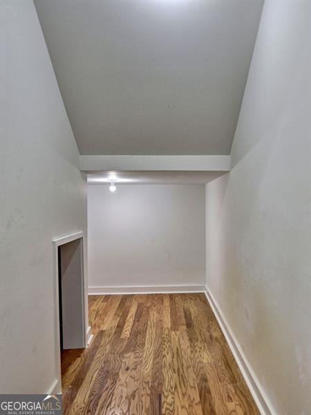 interior space featuring hardwood / wood-style flooring and lofted ceiling