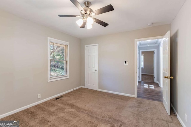 unfurnished bedroom with ceiling fan, crown molding, and light carpet