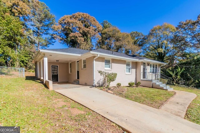 single story home featuring a front lawn and a carport