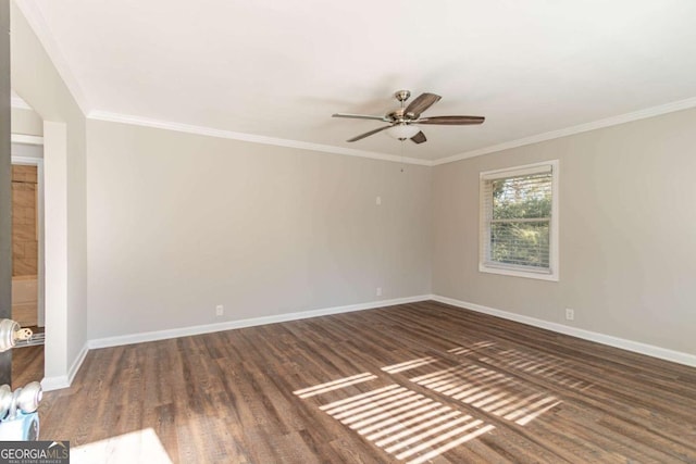 spare room featuring ceiling fan, dark hardwood / wood-style flooring, and crown molding