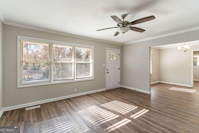 interior space with ceiling fan with notable chandelier, crown molding, and dark wood-type flooring