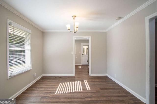 unfurnished room featuring ornamental molding, dark hardwood / wood-style flooring, and a notable chandelier