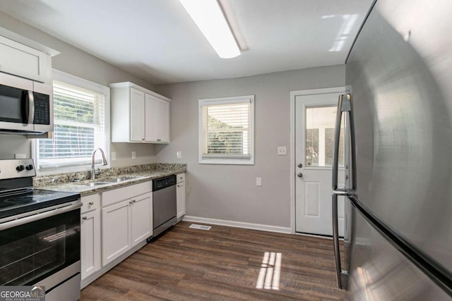 kitchen with white cabinetry, a wealth of natural light, sink, and appliances with stainless steel finishes