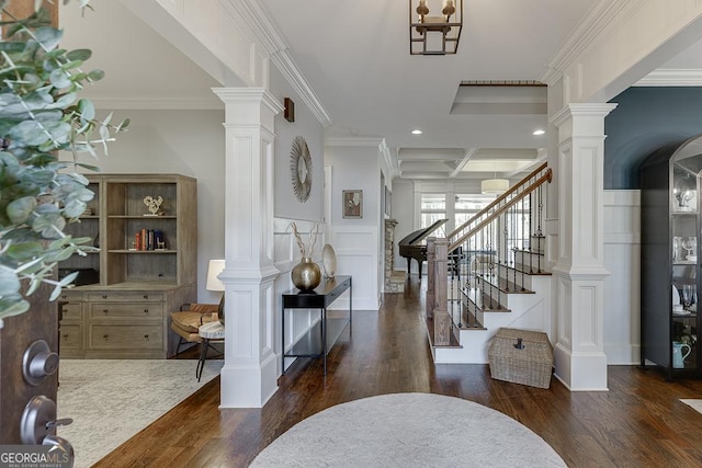 foyer featuring beam ceiling, dark hardwood / wood-style flooring, and ornamental molding