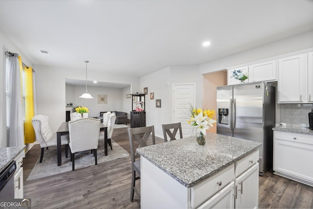 kitchen featuring light stone countertops, white cabinetry, stainless steel appliances, dark hardwood / wood-style flooring, and a kitchen island