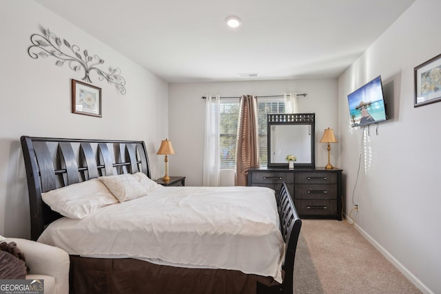 bedroom featuring light colored carpet