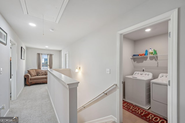 clothes washing area with washer and dryer and light carpet