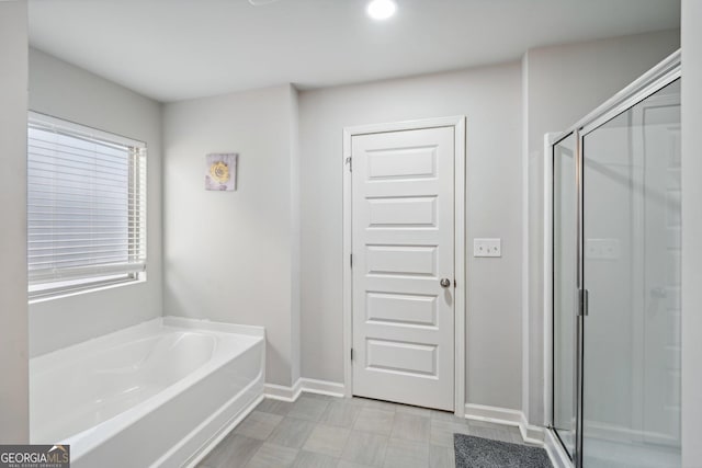 bathroom with shower with separate bathtub