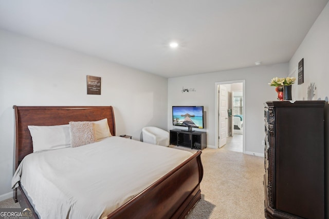 carpeted bedroom featuring connected bathroom