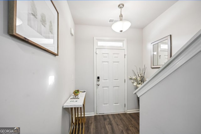 entryway with dark hardwood / wood-style flooring