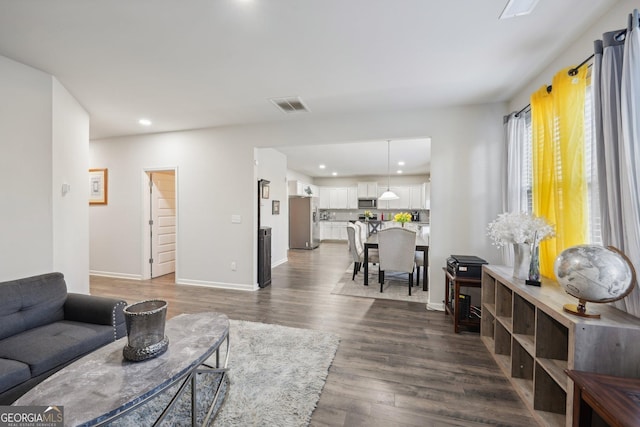 living room featuring dark wood-type flooring