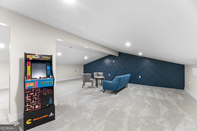 living area featuring lofted ceiling with beams and light colored carpet