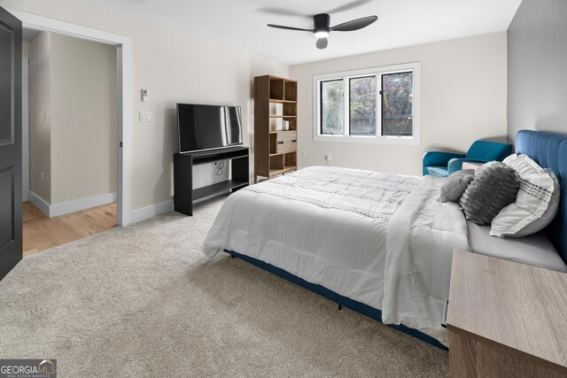 bedroom featuring ceiling fan and light carpet