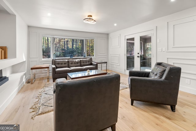 living room featuring light hardwood / wood-style flooring and french doors