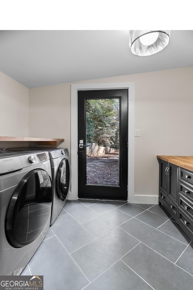 washroom featuring tile patterned floors and washing machine and dryer