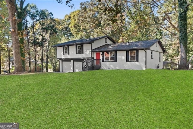 view of front of home featuring a front yard and a garage