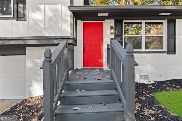 view of exterior entry with a garage