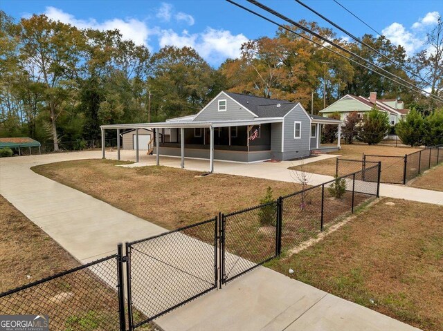 view of front of house with a carport and a front lawn