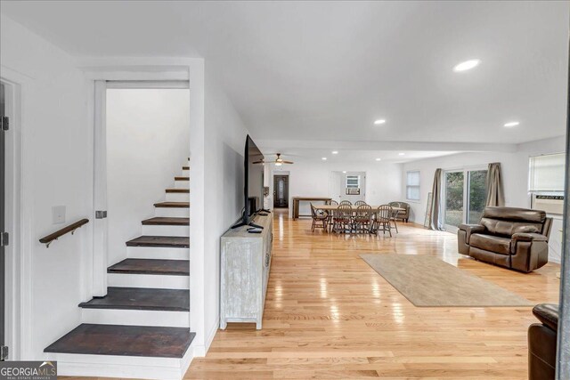 living room with ceiling fan and light hardwood / wood-style flooring