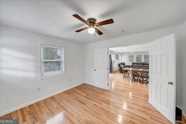 spare room featuring ceiling fan and light wood-type flooring