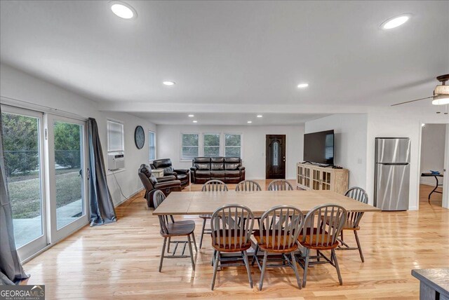 dining room featuring light hardwood / wood-style floors, a wealth of natural light, and ceiling fan