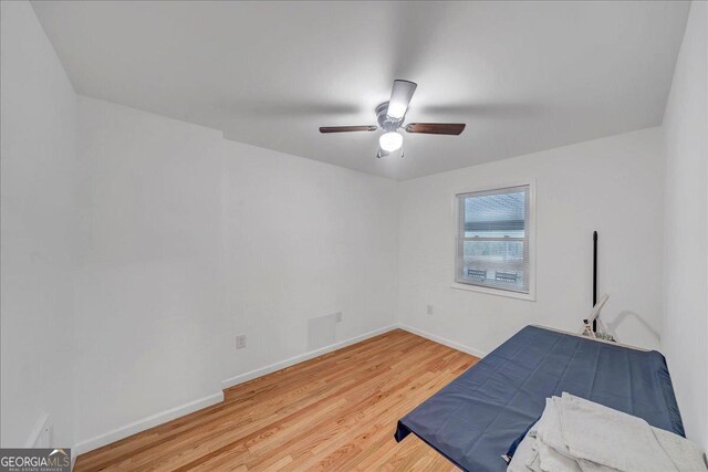 bedroom featuring light hardwood / wood-style flooring and ceiling fan