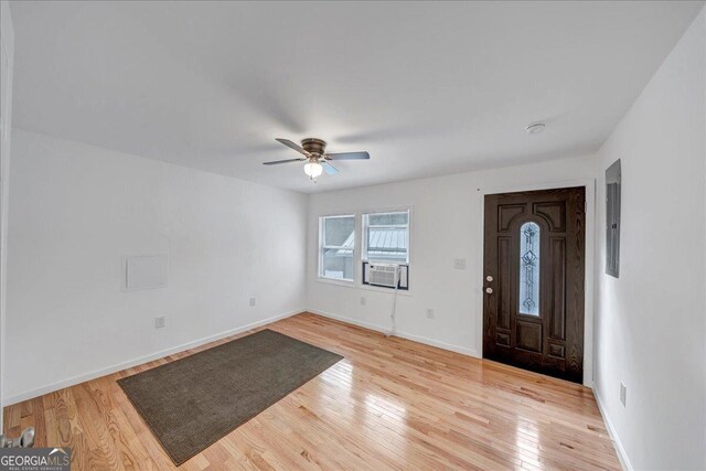 foyer featuring ceiling fan, cooling unit, and light wood-type flooring