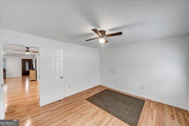 unfurnished room with ceiling fan and wood-type flooring