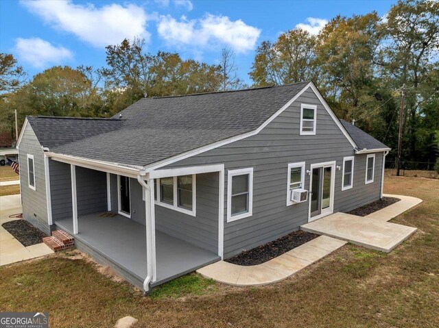 back of house with cooling unit, a patio area, and a yard