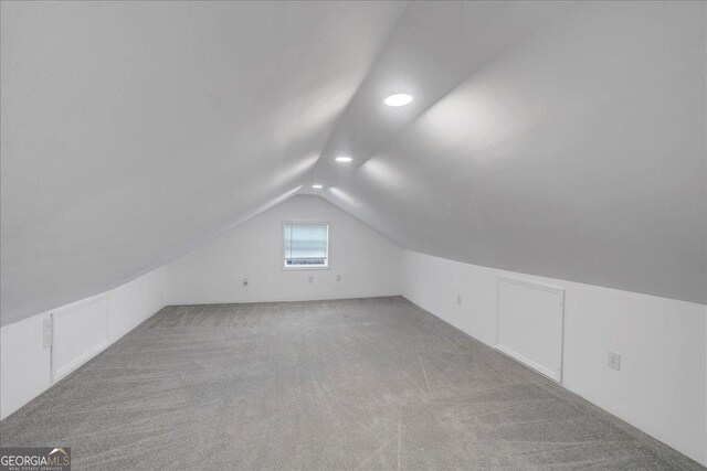 bonus room featuring carpet and vaulted ceiling