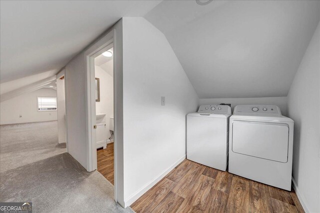 washroom with hardwood / wood-style floors and washer and dryer