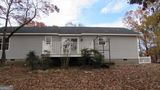 rear view of house with a wooden deck