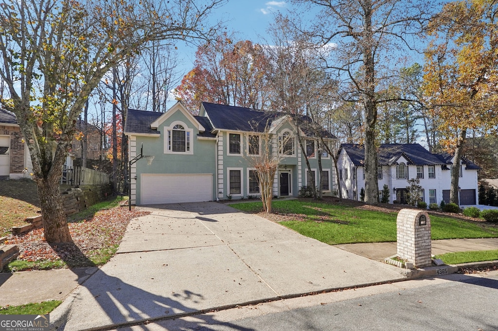 view of front of property featuring a garage and a front yard