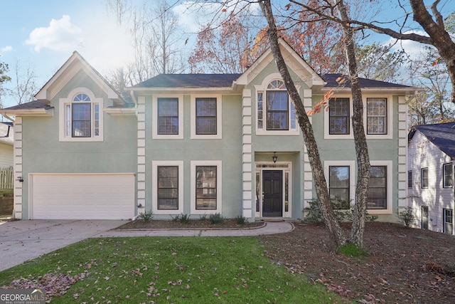 view of front of home featuring a front yard and a garage