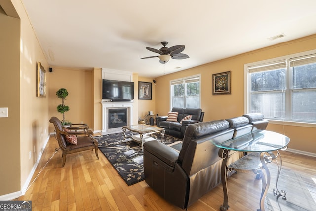 living room featuring ceiling fan and light wood-type flooring