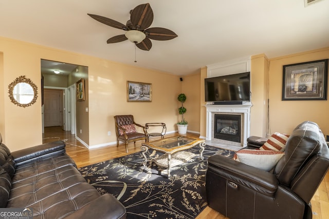 living room with ceiling fan and light wood-type flooring