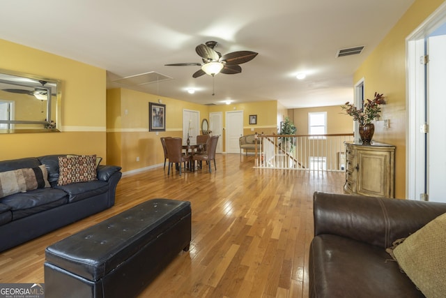 living room featuring ceiling fan and light hardwood / wood-style floors