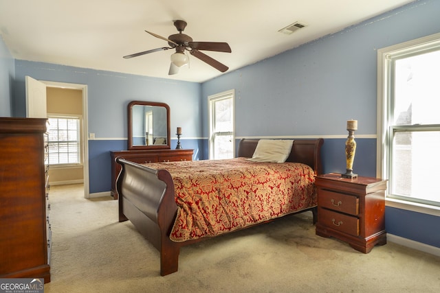 bedroom featuring light carpet and ceiling fan