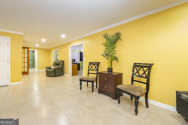 sitting room with ornamental molding and french doors