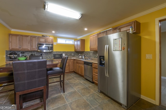 kitchen featuring sink, crown molding, backsplash, and appliances with stainless steel finishes