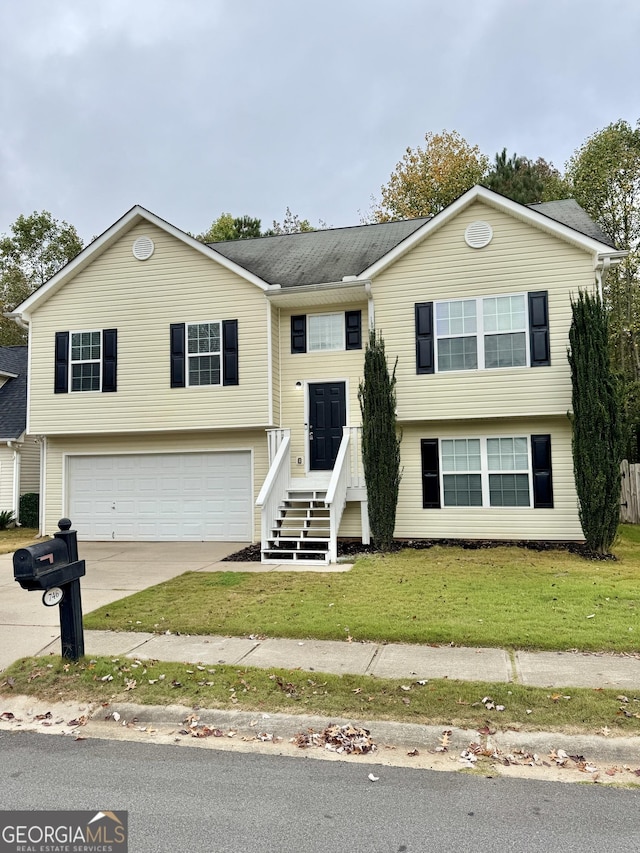 split foyer home with a garage and a front lawn