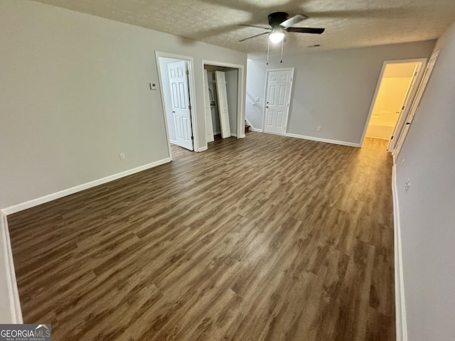 spare room with ceiling fan, dark wood-type flooring, and a textured ceiling